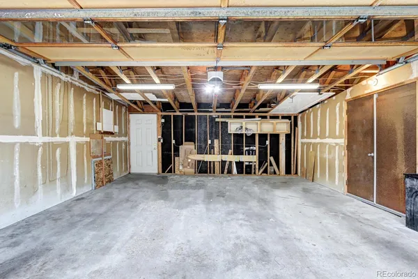 a view of an empty room with wooden stairs