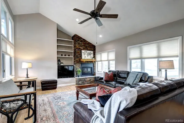 a living room with furniture ceiling fan and a window