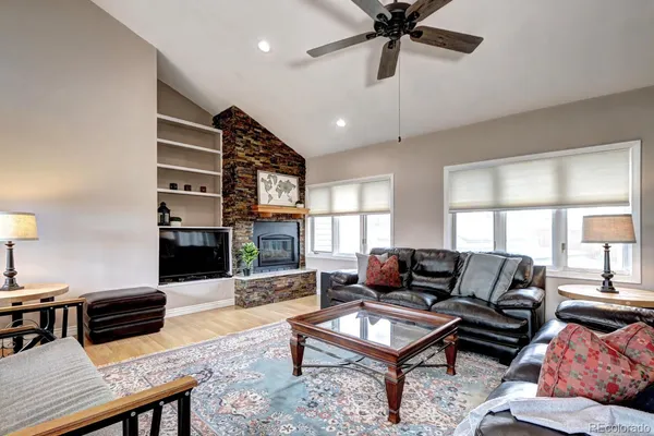 a living room with furniture a fireplace and a flat screen tv