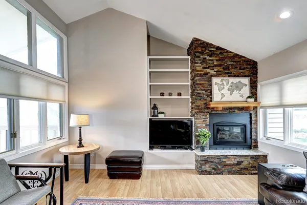 a living room with furniture fireplace and window