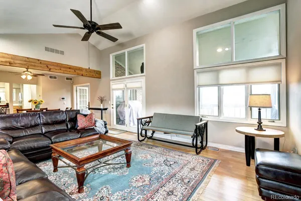a living room with furniture a rug and a large window