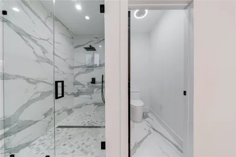 a bathroom with a granite countertop shower