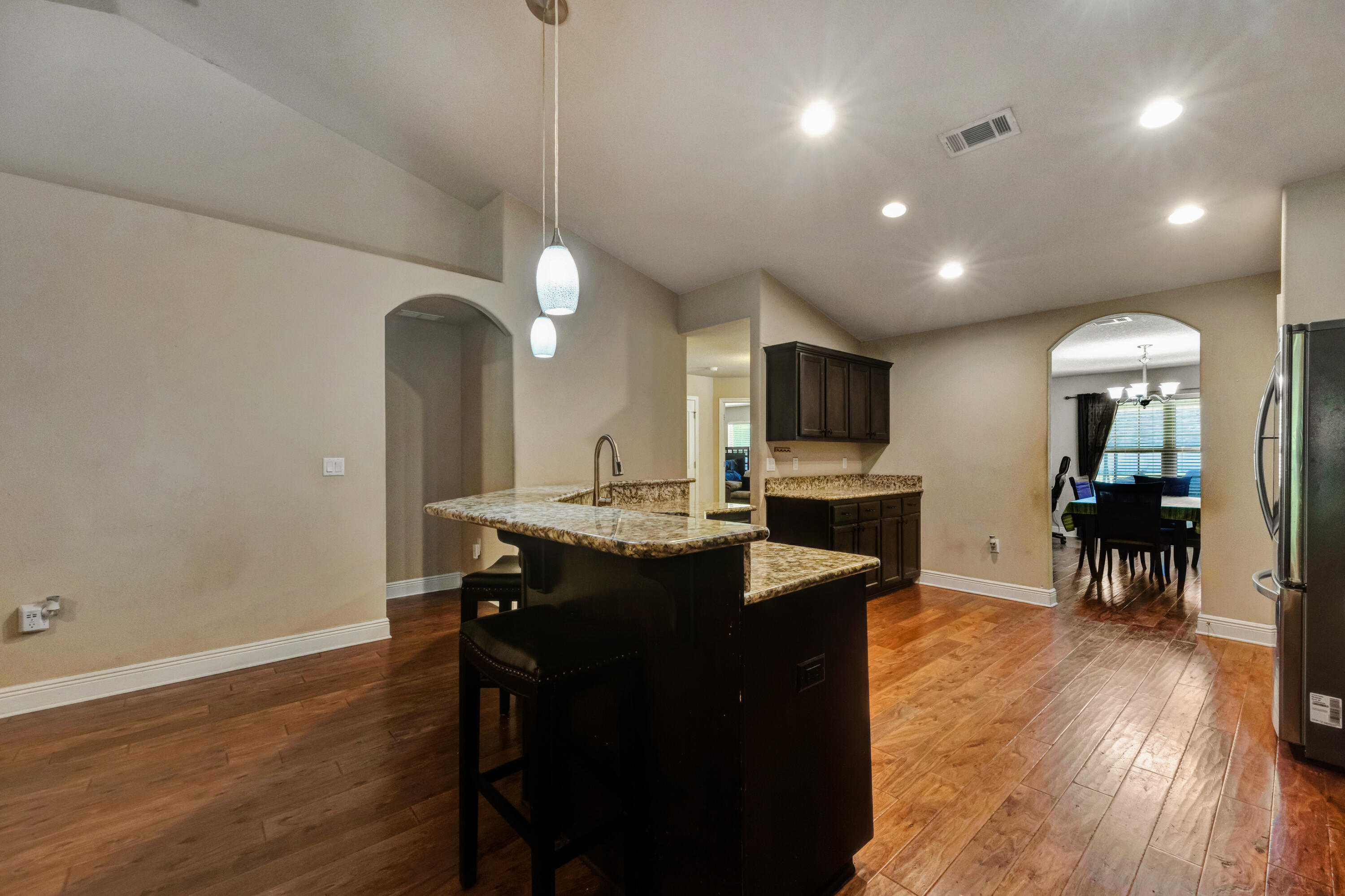 2428 Genevieve Way Crestview, FL 32536 - Photo 12 of 53 a kitchen with stainless steel appliances granite countertop a sink a stove and a wooden floors