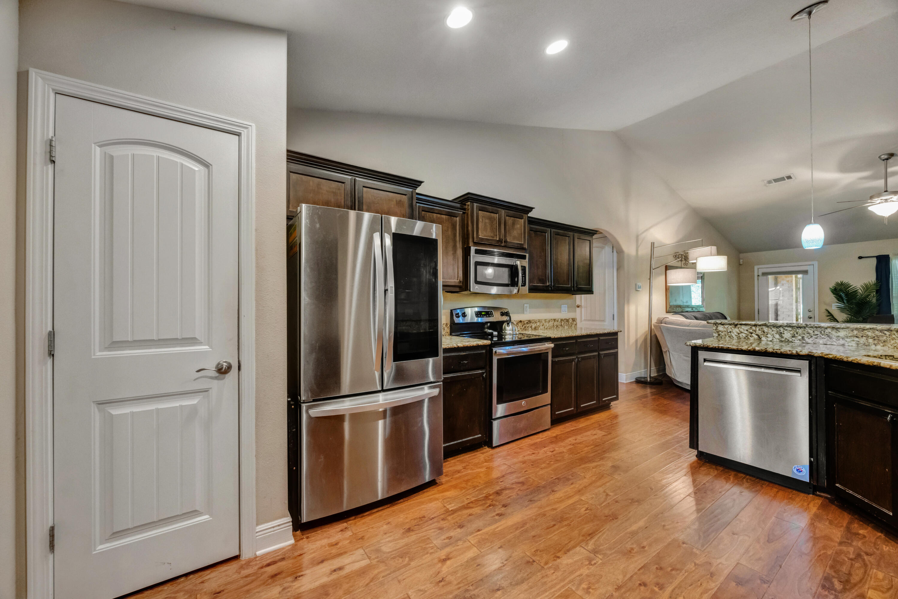 2428 Genevieve Way Crestview, FL 32536 - Photo 13 of 53 a kitchen with stainless steel appliances granite countertop a refrigerator microwave and stove
