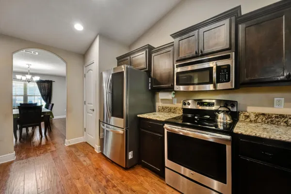 a kitchen with granite countertop stainless steel appliances and wooden cabinets