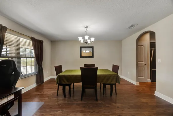 a view of a dining room with furniture and a window