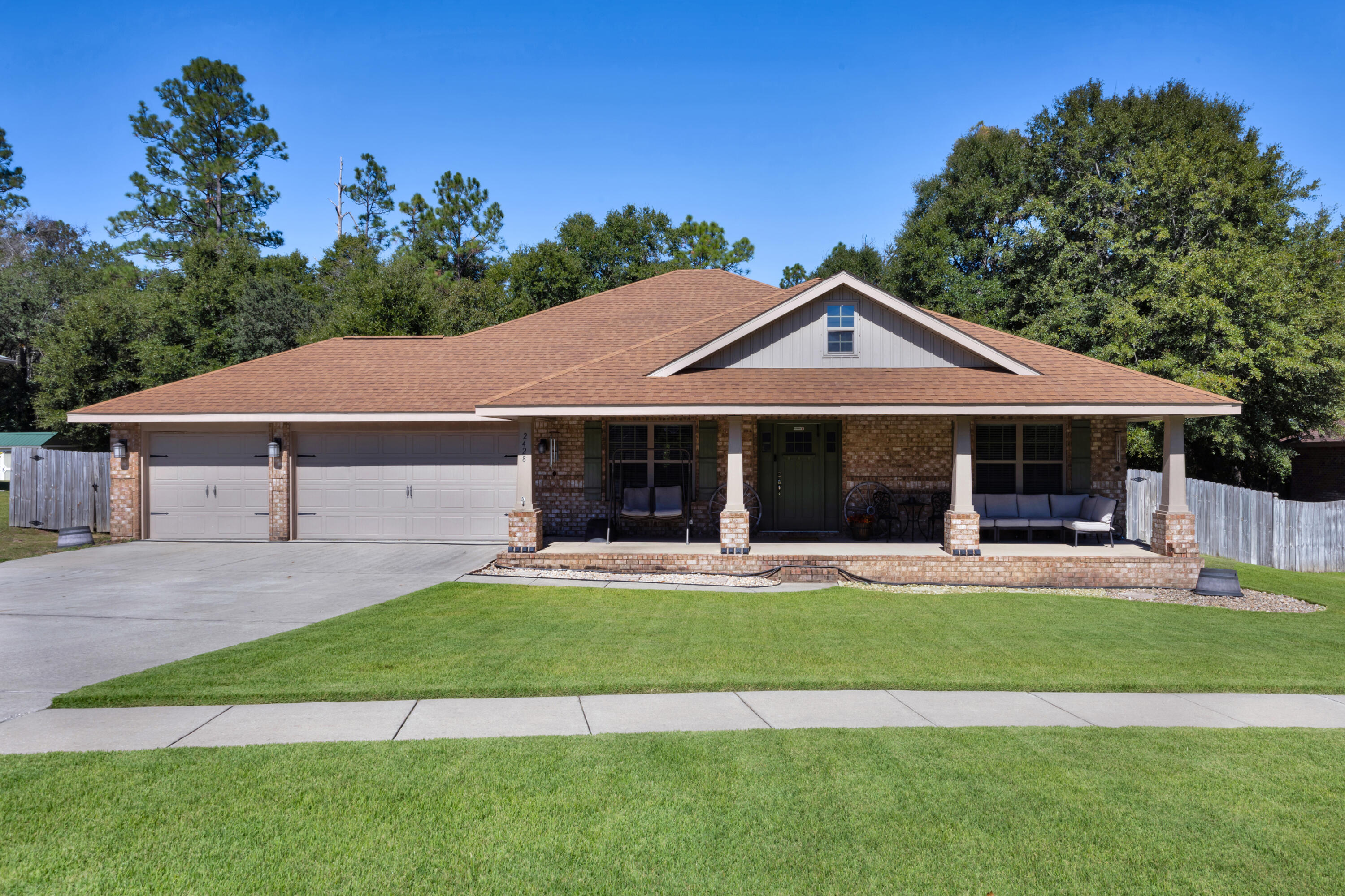 2428 Genevieve Way Crestview, FL 32536 - Photo 2 of 53 a front view of a house with a yard table and chairs