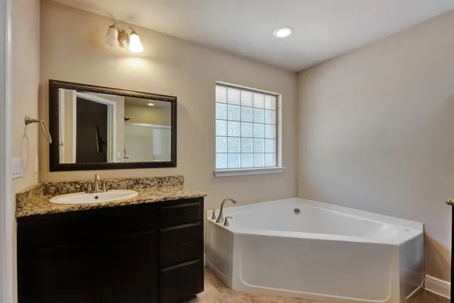a bathroom with a double vanity sink mirror and shower
