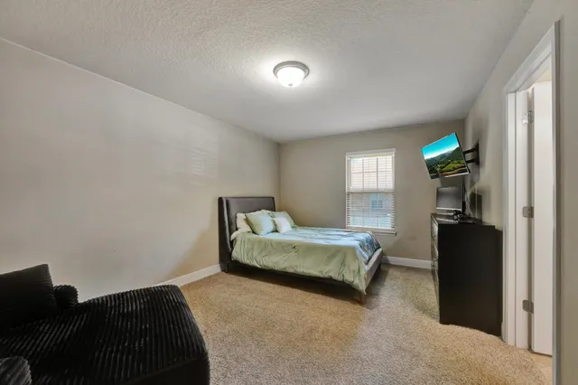 a bedroom with a bed and a walk in closet