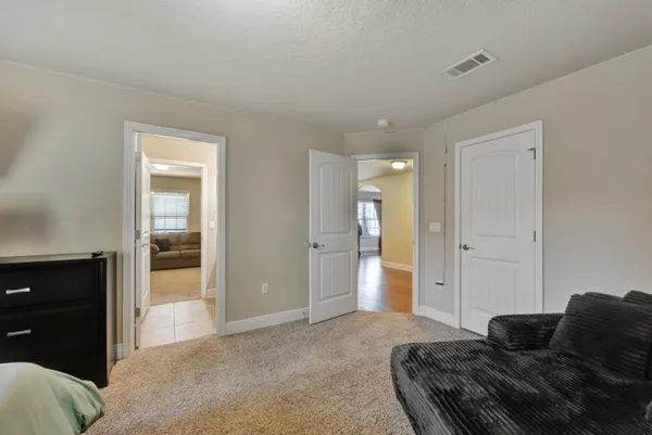 a living room with a couch and a piano