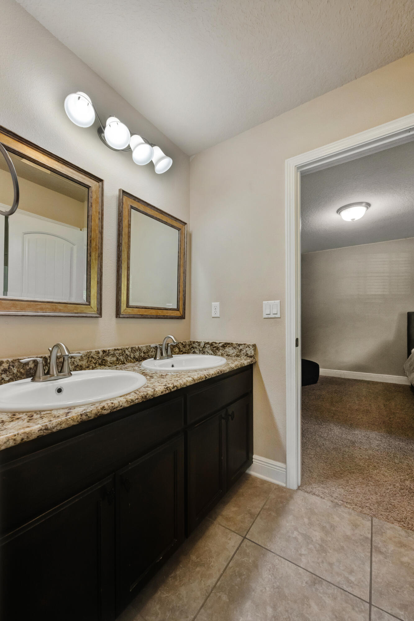 2428 Genevieve Way Crestview, FL 32536 - Photo 31 of 53 a bathroom with a double vanity sink and a mirror