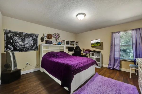 a bedroom with a bed and a dresser