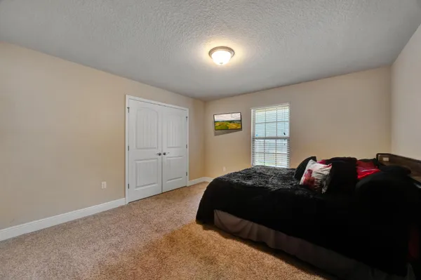 a bathroom with a granite countertop sink toilet and mirror