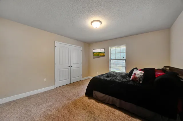 a bathroom with a granite countertop sink toilet and mirror