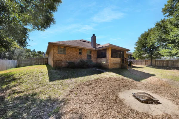 a aerial view of a house next to a big yard