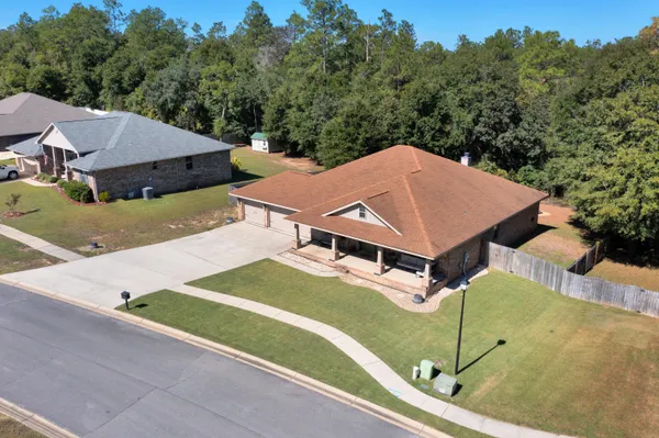 an aerial view of residential houses with outdoor space
