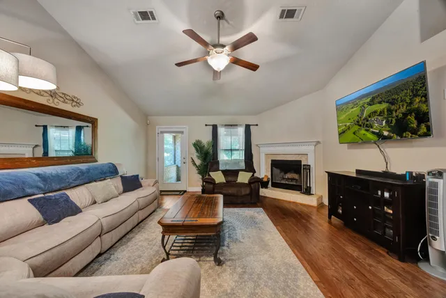a living room with furniture and a flat screen tv