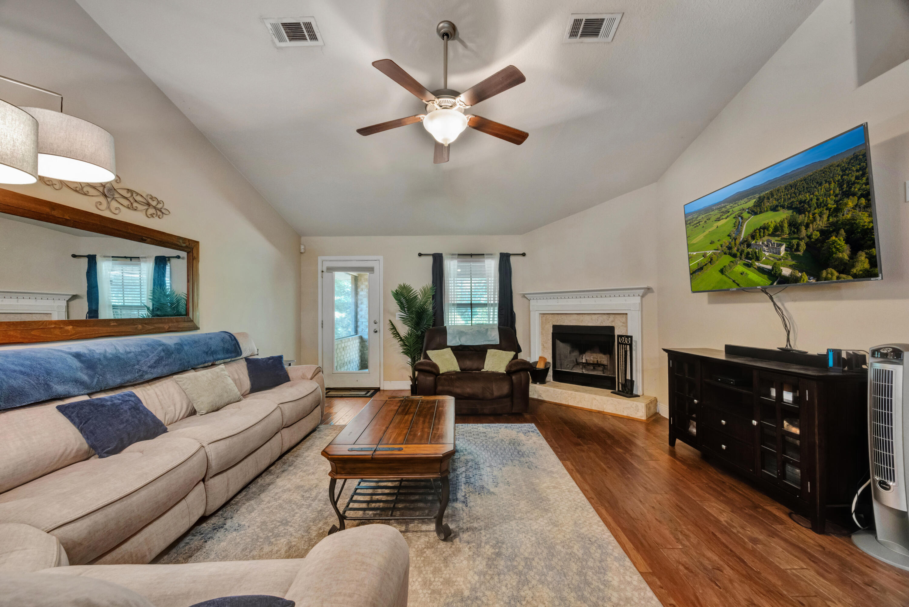 2428 Genevieve Way Crestview, FL 32536 - Photo 6 of 53 a living room with furniture a fireplace and a flat screen tv