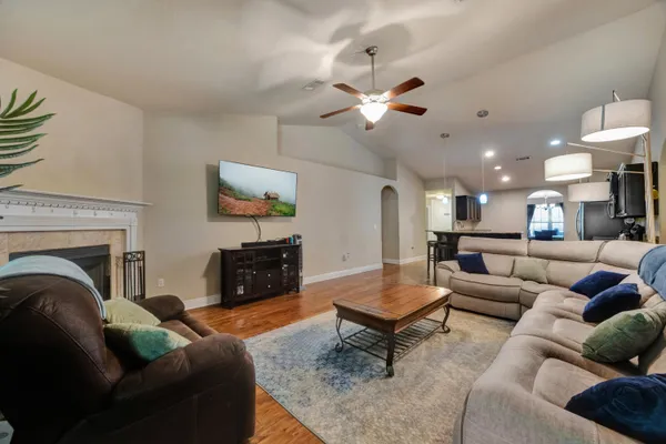 a living room with furniture and kitchen view