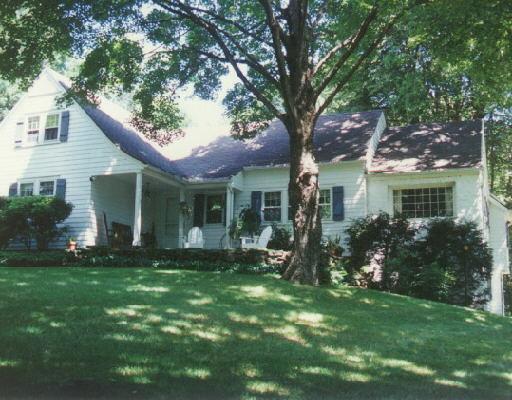 a front view of house with a garden and porch