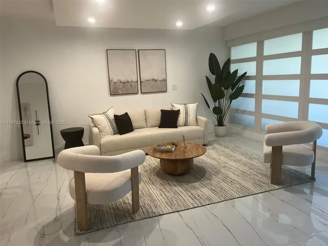 a living room with furniture and a potted plant