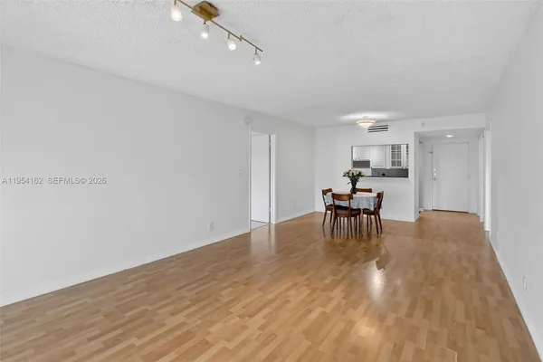 a view of a kitchen with dining table and chairs