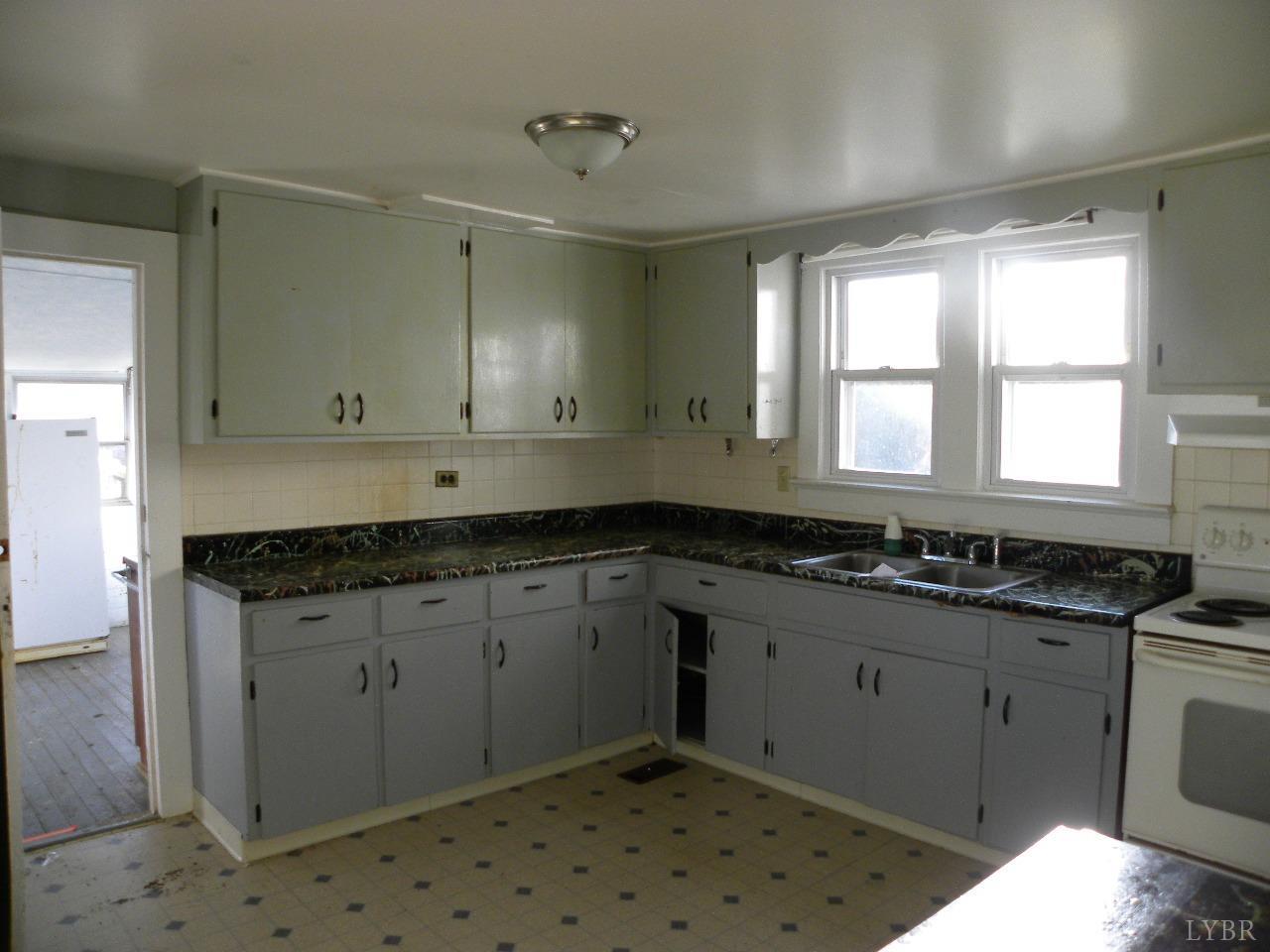 5797 Scuffletown Road Randolph, VA 23962 - Photo 7 of 18 a kitchen with granite countertop a sink stove and cabinets