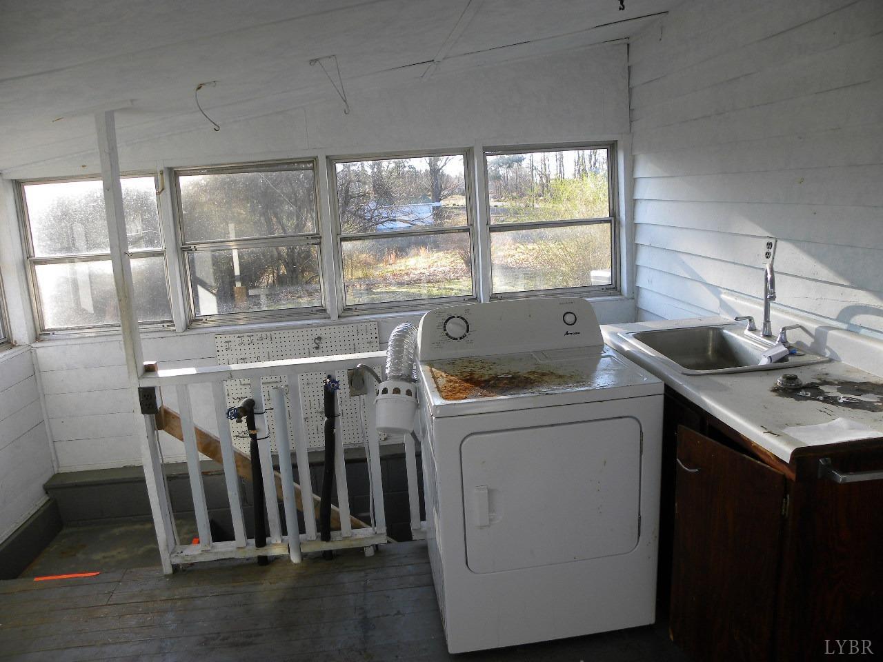 5797 Scuffletown Road Randolph, VA 23962 - Photo 8 of 18 a kitchen with a sink a window and cabinets