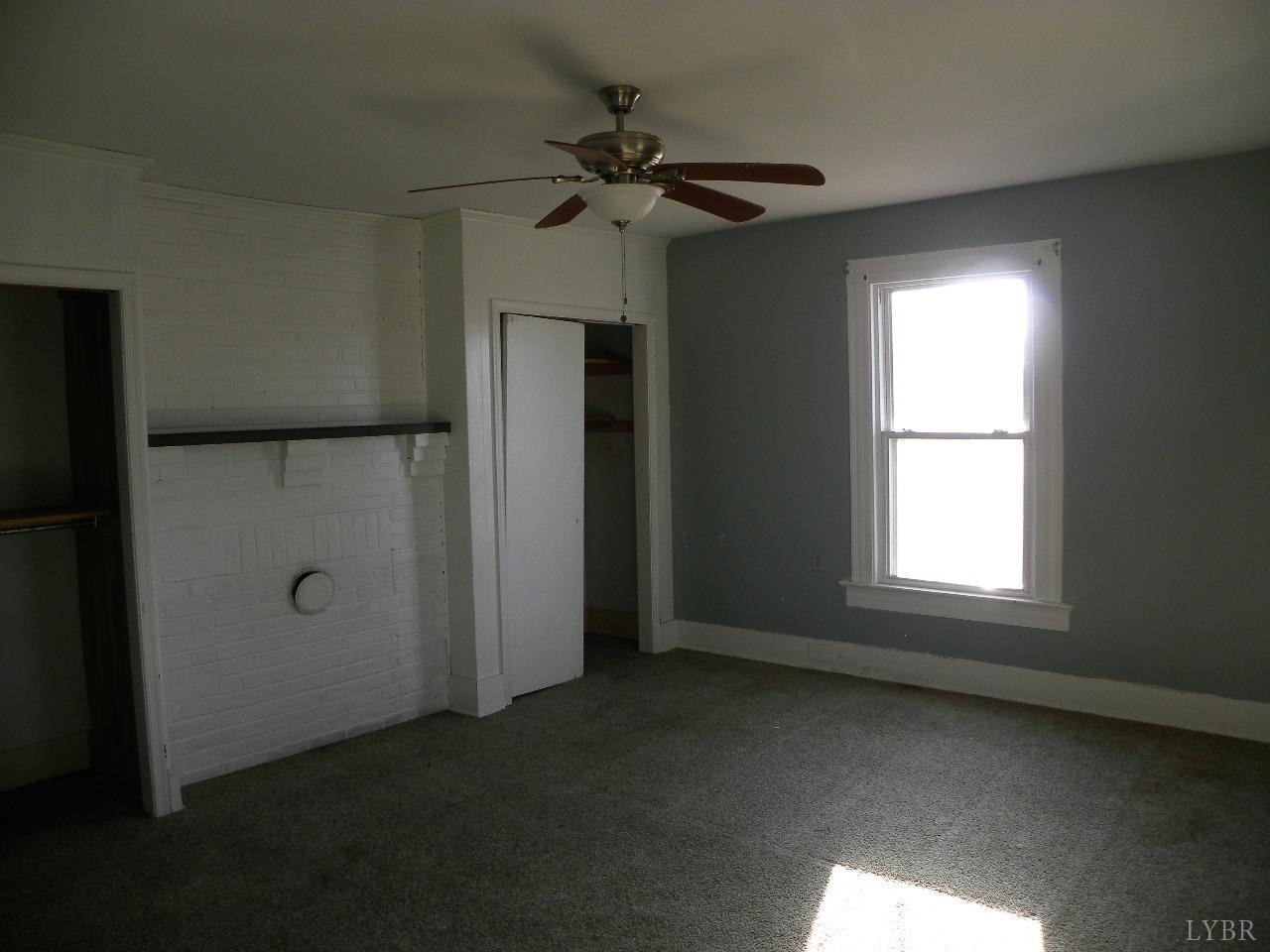 5797 Scuffletown Road Randolph, VA 23962 - Photo 9 of 18 an empty room with a window and a ceiling fan