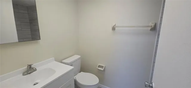 a white toilet sitting next to a bathroom sink