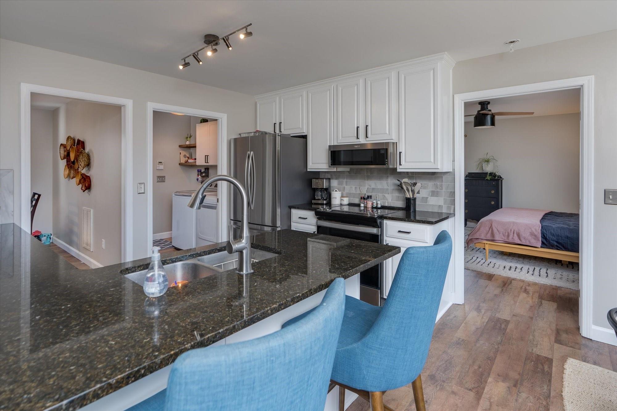 531 Sloping Meadow Mill Spring, NC 28756 - Photo 12 of 46 a kitchen with stainless steel appliances granite countertop a sink refrigerator and microwave