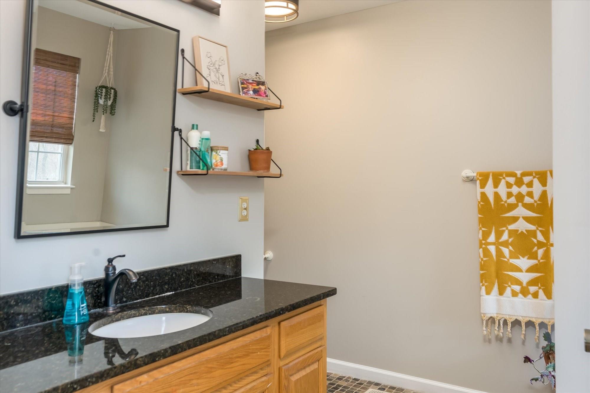 531 Sloping Meadow Mill Spring, NC 28756 - Photo 20 of 46 a bathroom with a granite countertop sink and a mirror