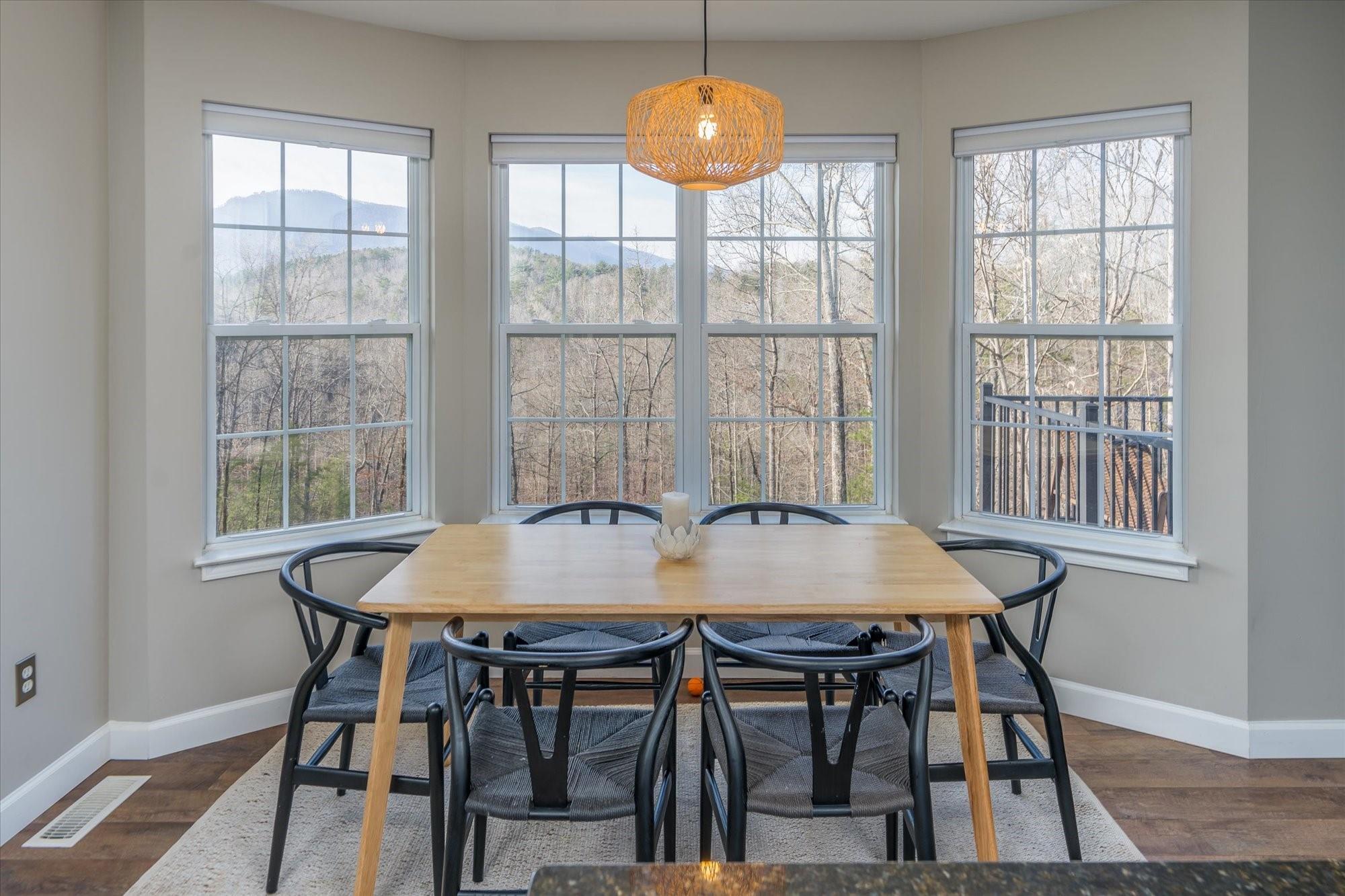 531 Sloping Meadow Mill Spring, NC 28756 - Photo 2 of 46 a view of a dining room with furniture and wooden floor