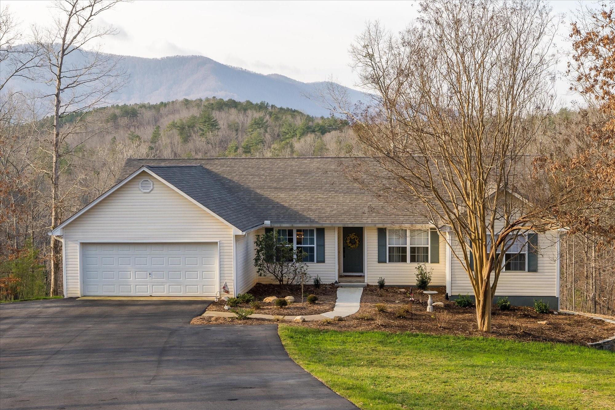 531 Sloping Meadow Mill Spring, NC 28756 - Photo 3 of 46 a front view of house with yard and outdoor seating