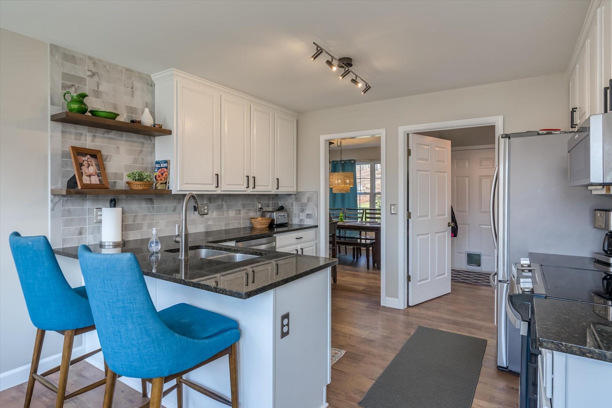 531 Sloping Meadow Mill Spring, NC 28756 - Photo 4 of 46 a kitchen with stainless steel appliances granite countertop a refrigerator and a stove top oven