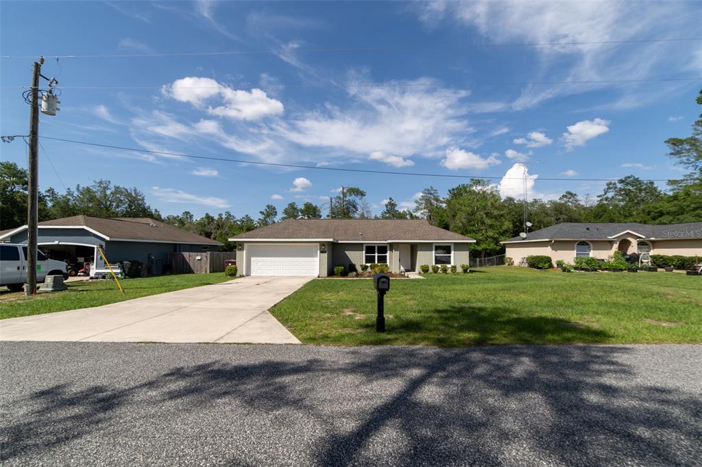 5107 Southwest 165th St Road Ocala, FL 34473 - Photo 1 of 34 a front view of a house with a garden