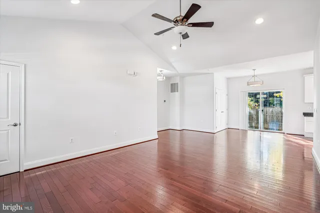 a view of wooden floor chandelier and window in a room