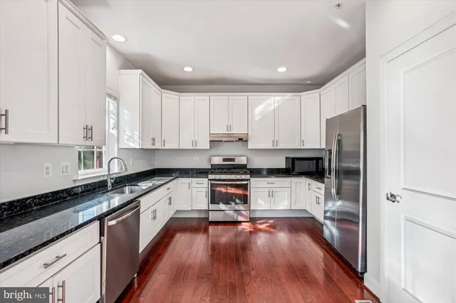 a kitchen with wooden cabinets and stainless steel appliances