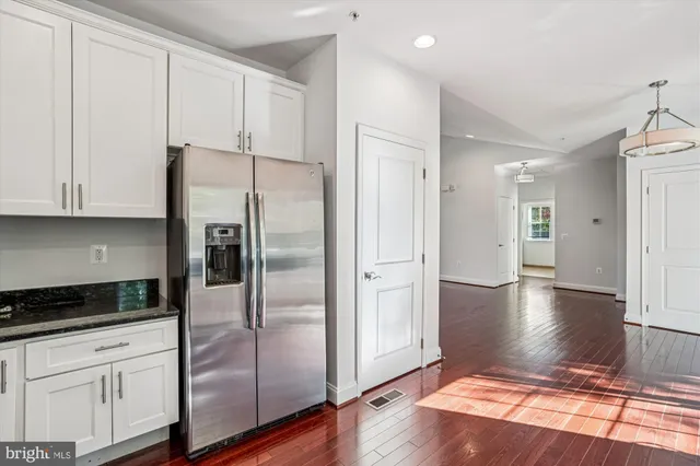 a kitchen with granite countertop a stove and a refrigerator