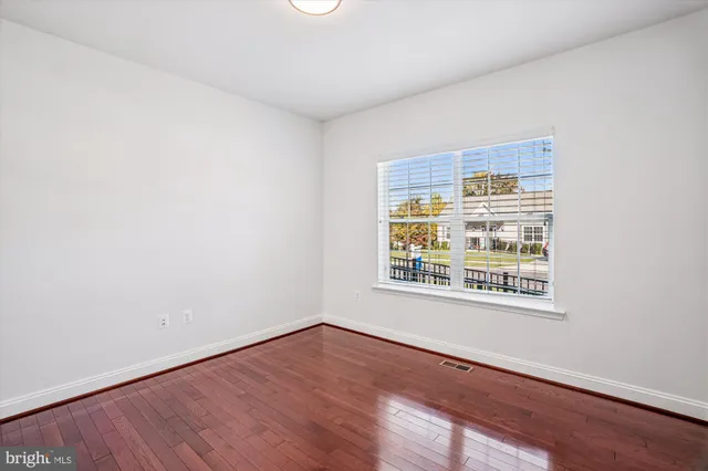 a view of a room with wooden floor and white walls