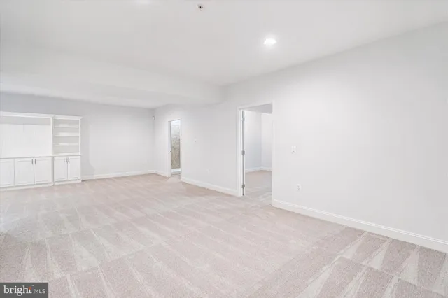 an empty room with a empty space and windows