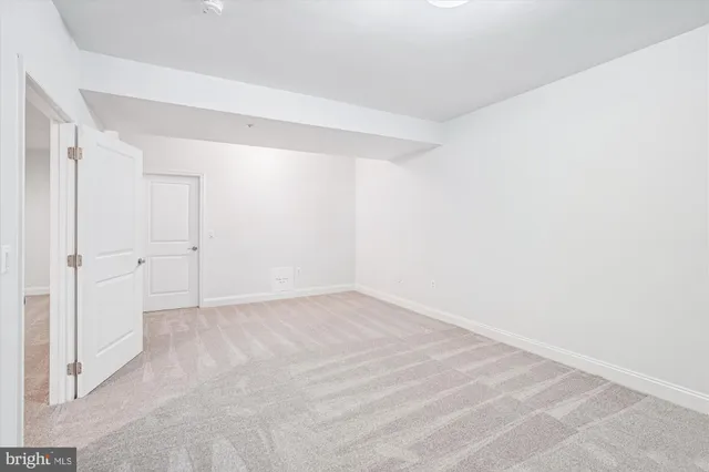 a bathroom with a granite countertop toilet and sink