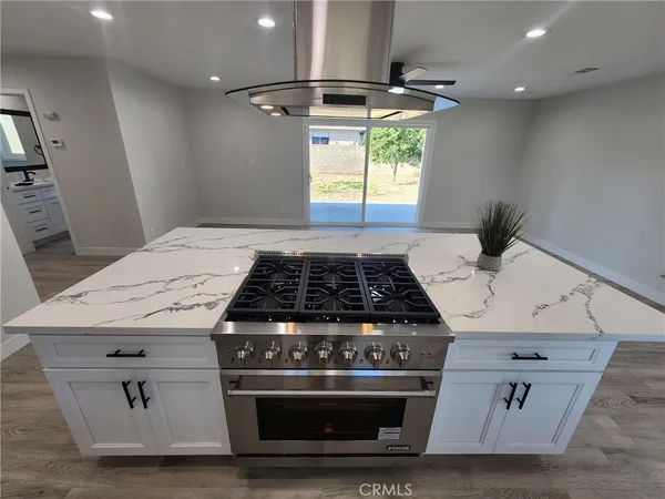 a stove top oven sitting inside of a kitchen