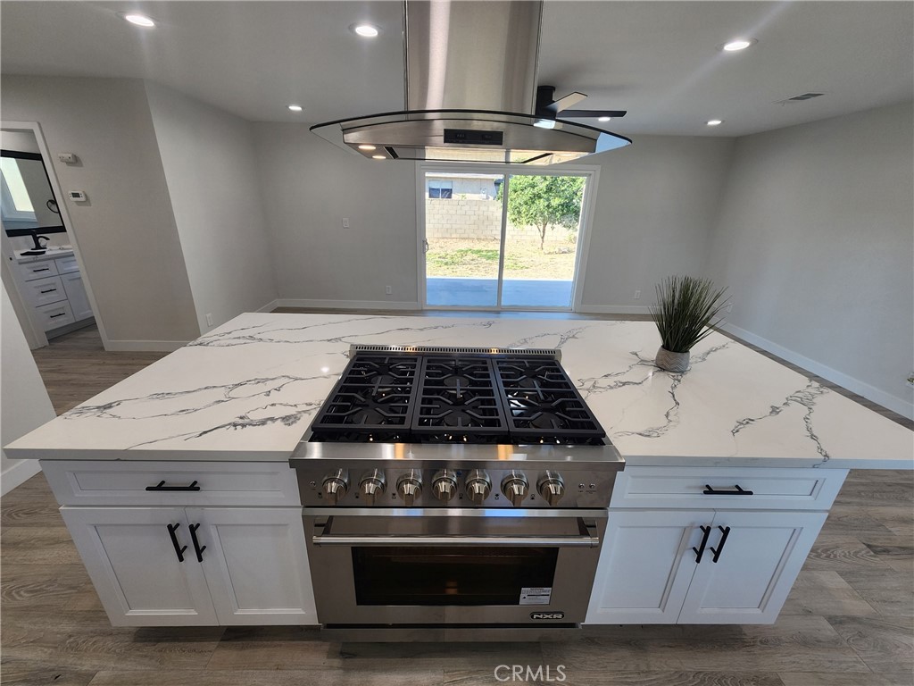 693 West Wilson Street Banning, CA 92220 - Photo 14 of 48 a stove top oven sitting inside of a kitchen
