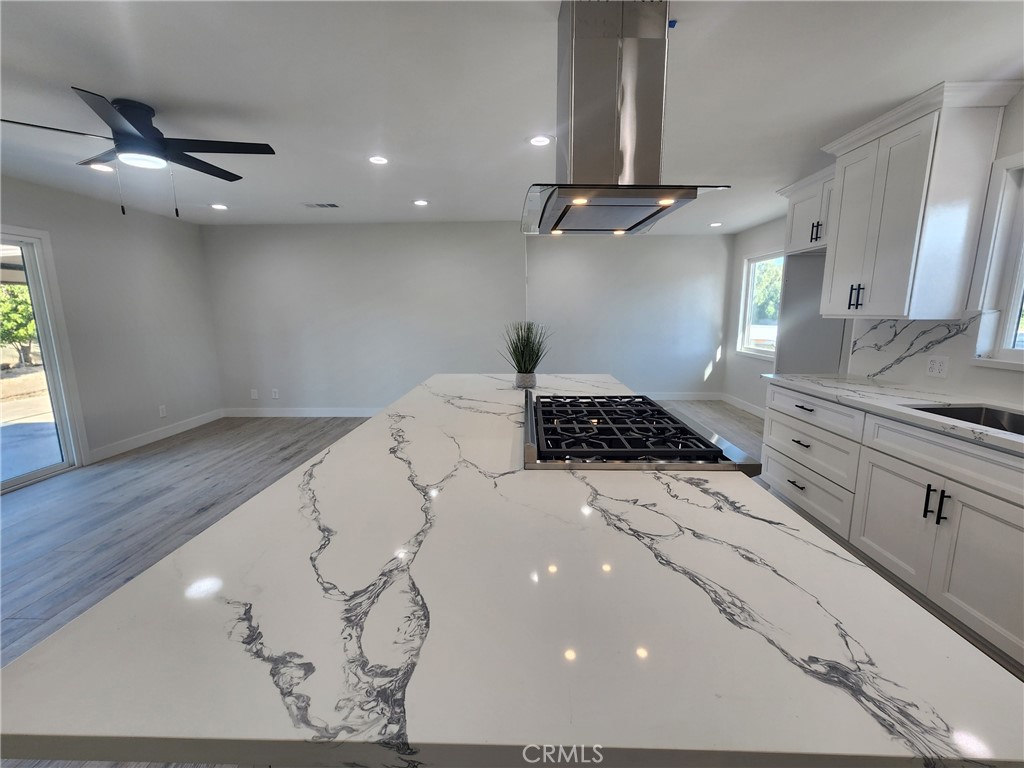 693 West Wilson Street Banning, CA 92220 - Photo 15 of 48 a kitchen with a sink stainless steel appliances and cabinets