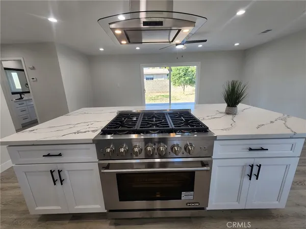 a stove top oven sitting inside of a kitchen
