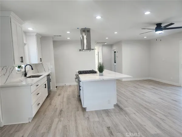 a kitchen with a sink stainless steel appliances and cabinets