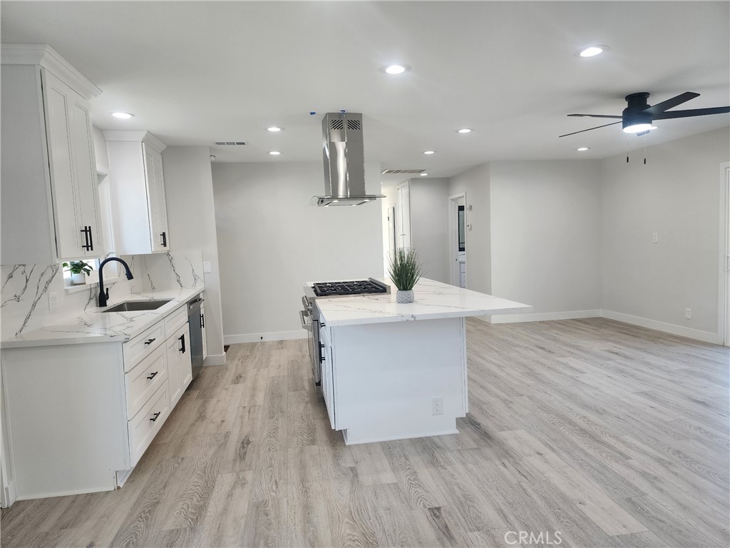 693 West Wilson Street Banning, CA 92220 - Photo 19 of 48 a kitchen with a sink stainless steel appliances and cabinets