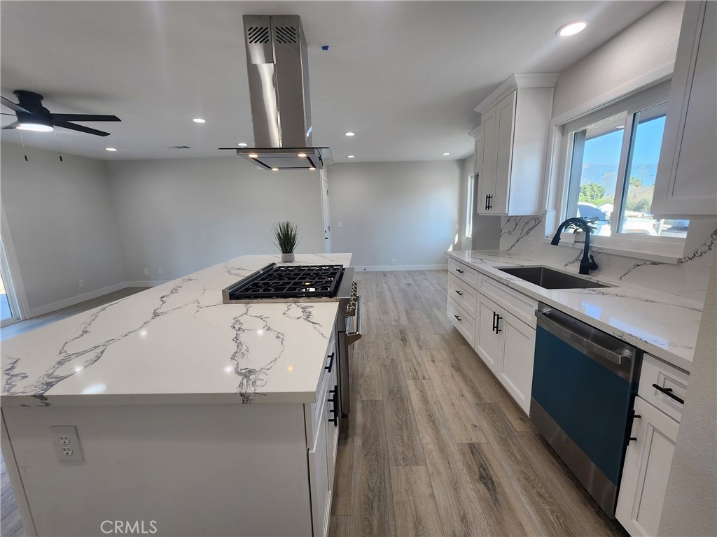 693 West Wilson Street Banning, CA 92220 - Photo 22 of 48 a kitchen with granite countertop a sink stainless steel appliances and cabinets