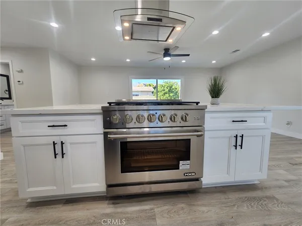 a stove top oven sitting inside of a kitchen